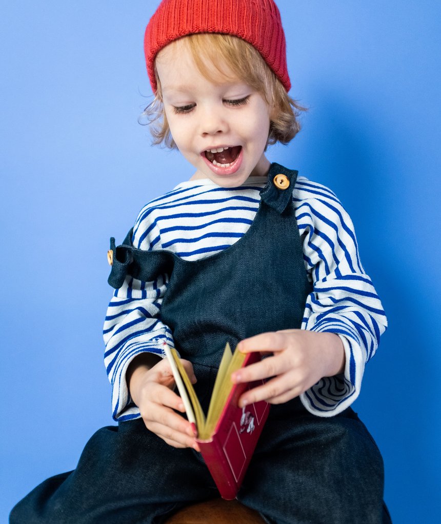 child excitedly reading a book
