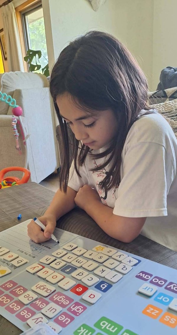 child playing phonics game