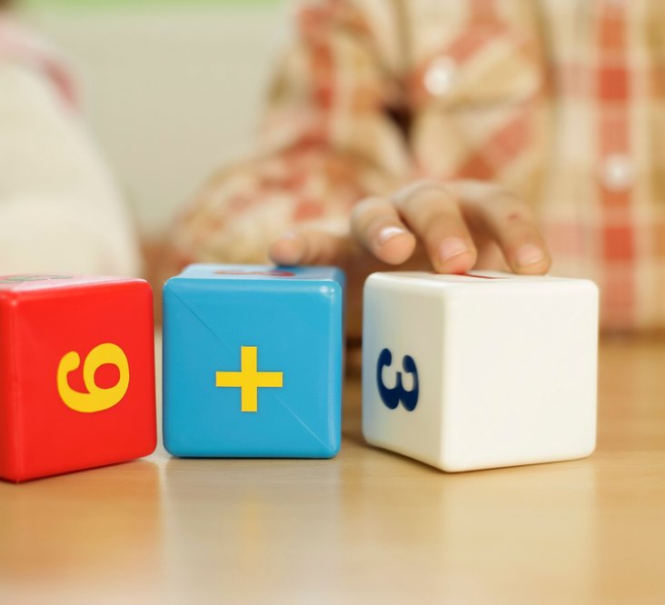 childs hands using math dice