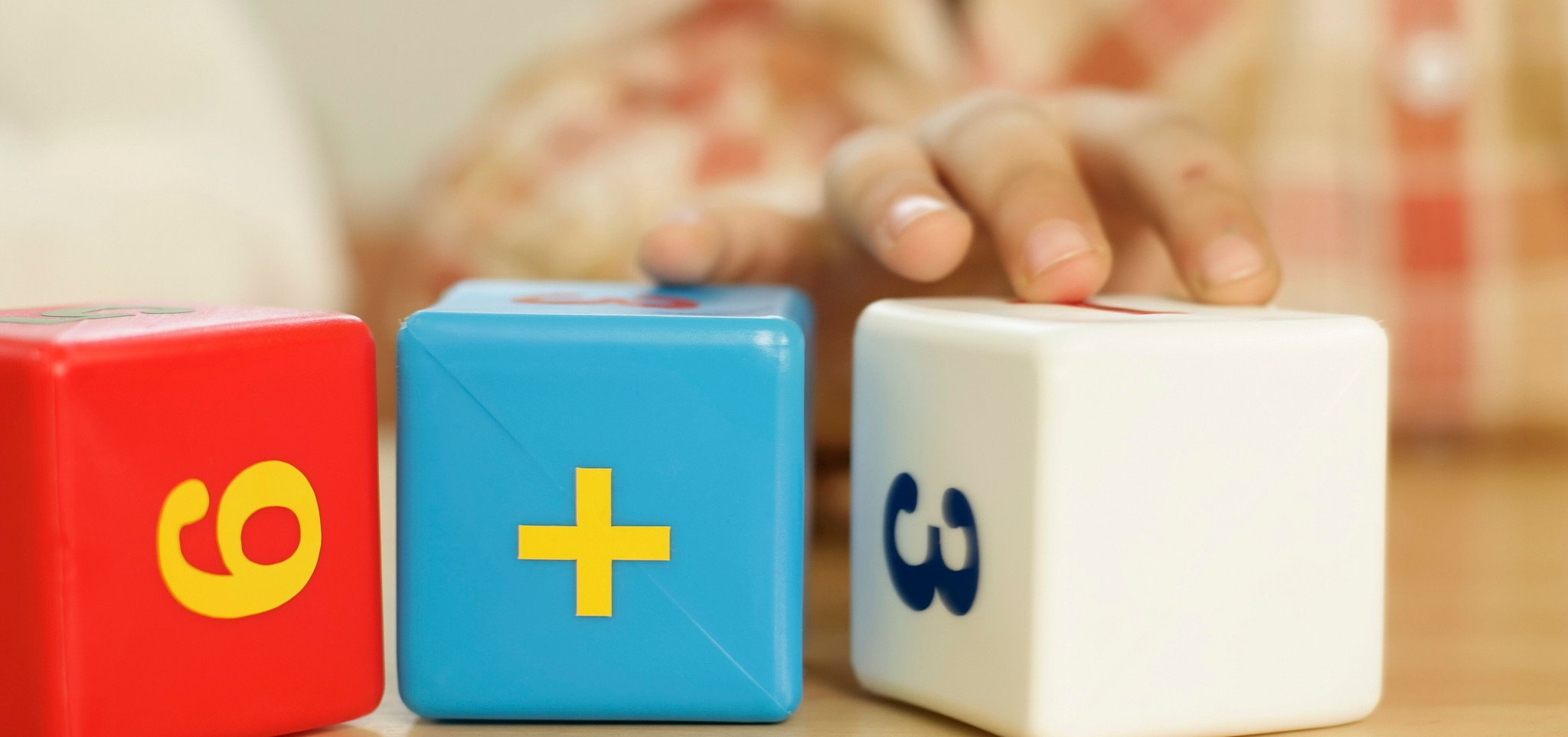 childs hand using dice