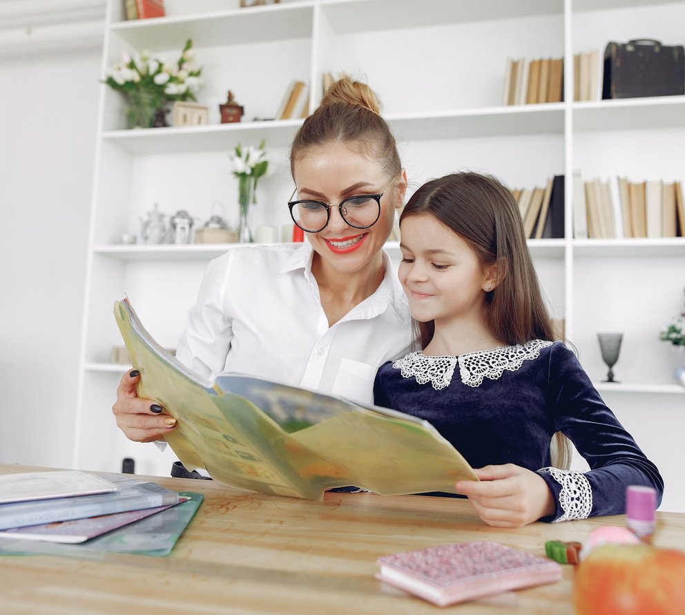 student and tutor reading together